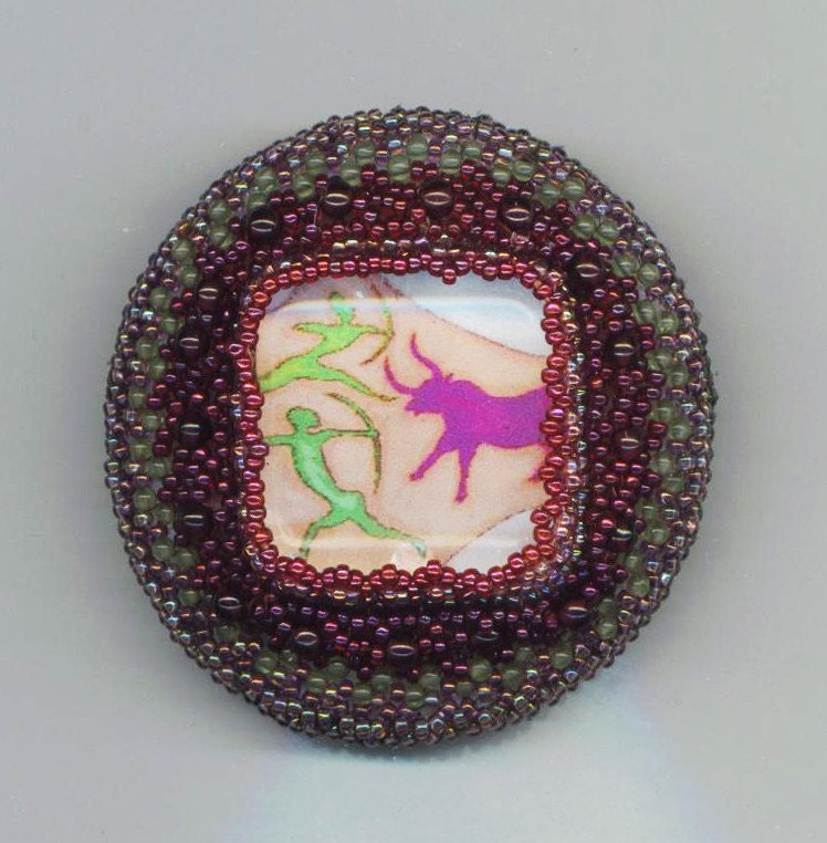Beadwoven/ Beaded Cave Painting Brooch . Arrowhead . Archer . Genuine Garnet Beads . Peridot Beads - Bull Hunters by enchantedbeads on Etsy
