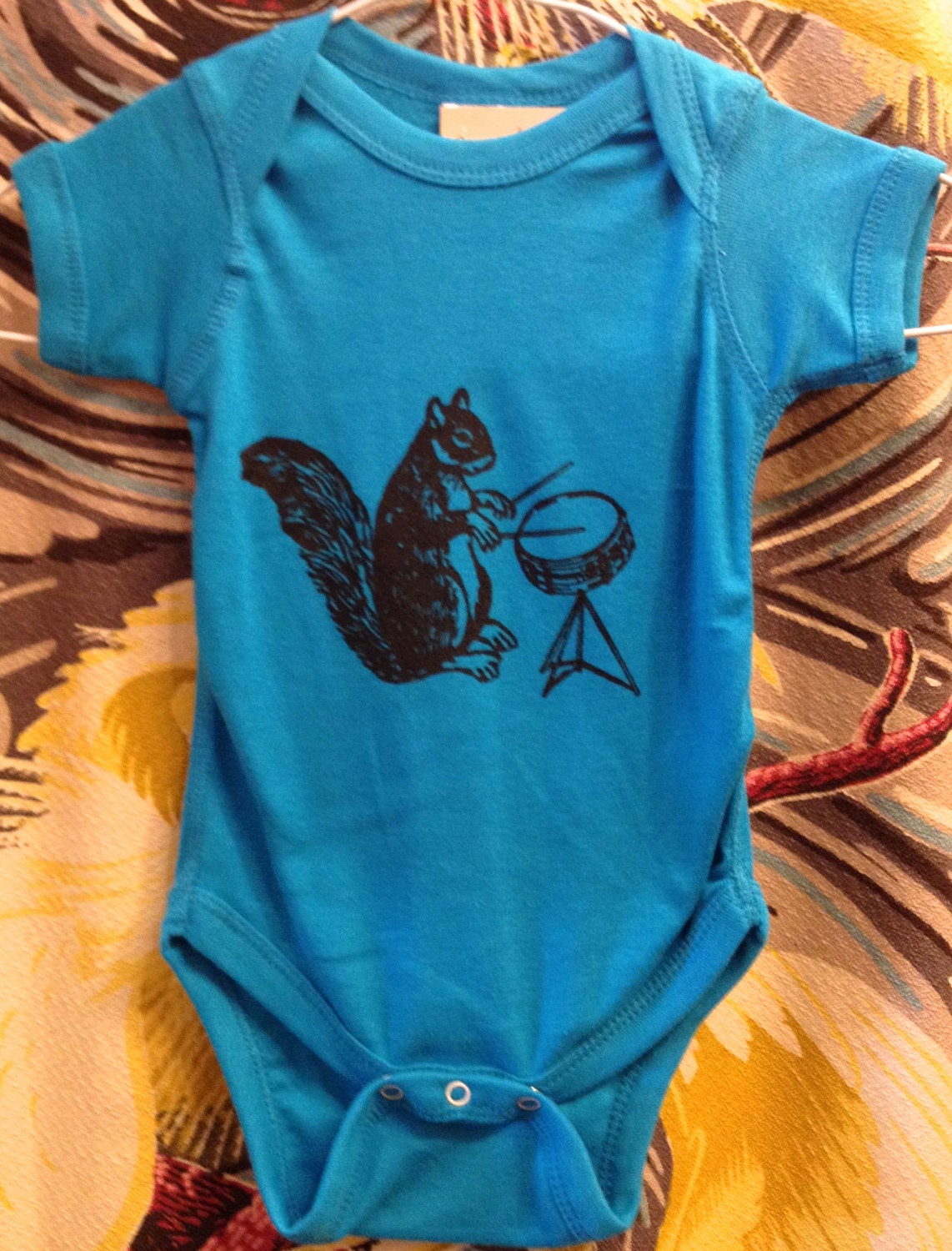 drumming squirrel onesie - turquoise