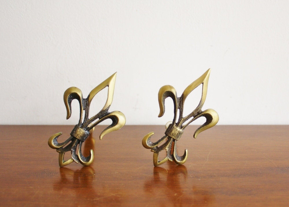 Vintage pair of brass fleur de lis curtain tie backs