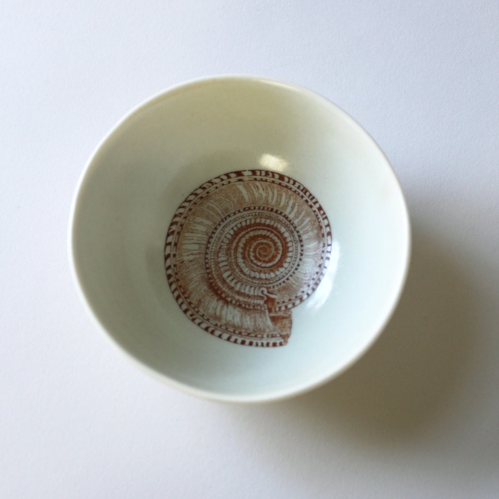 small roly poly bowl in pale sea-foam green with spiral shell