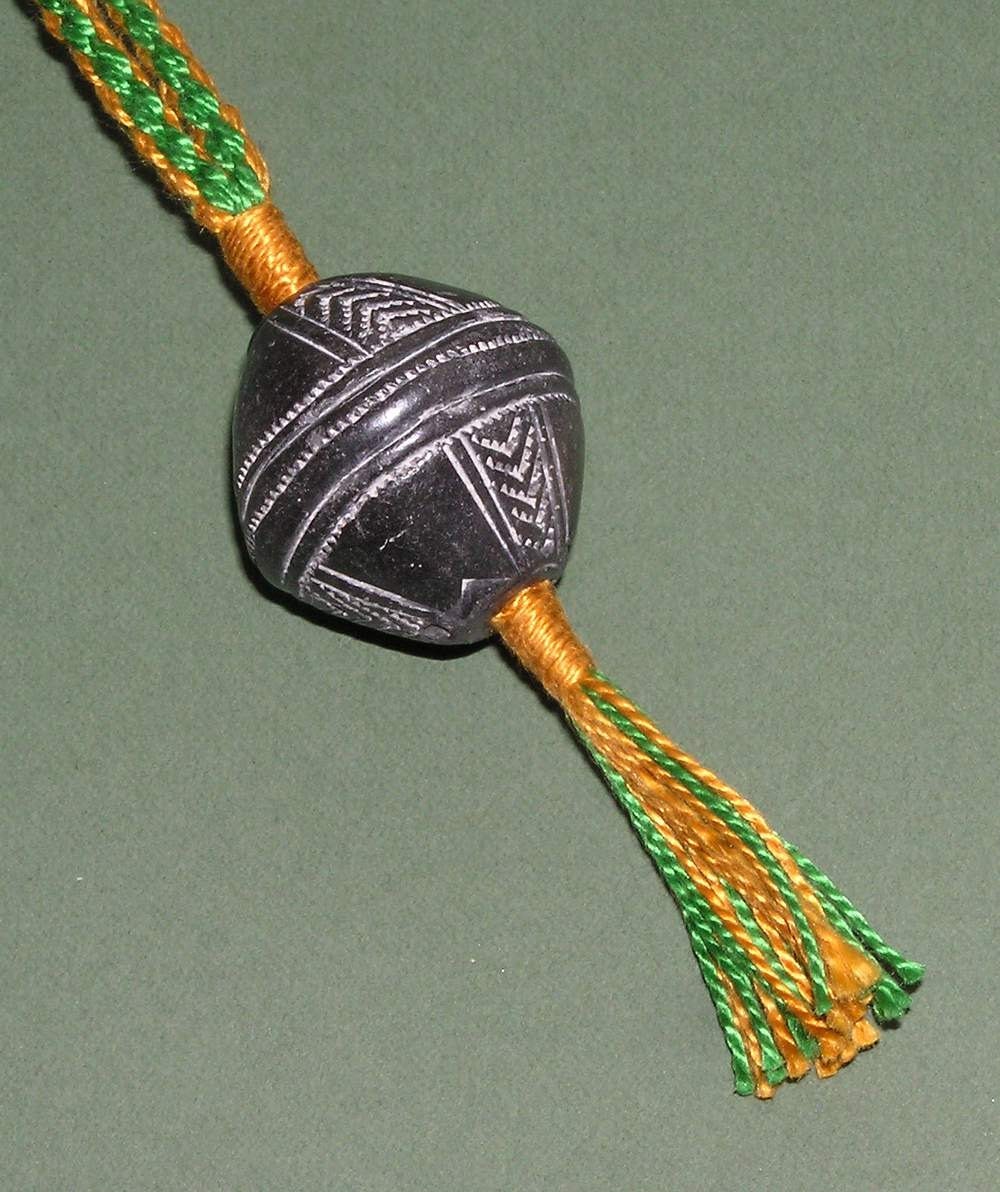 Wristaff - handmade braid with African bead-whorl