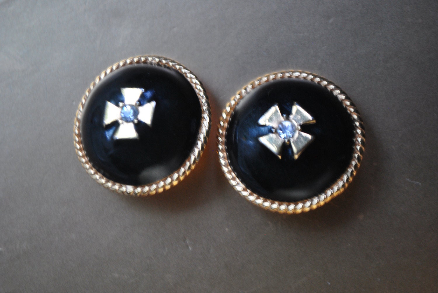Runway vintage 80s gold tone metal, large, round clip on earrings with navy blue enamel  and metal  cross as a centerpiece. Made by Ciner.
