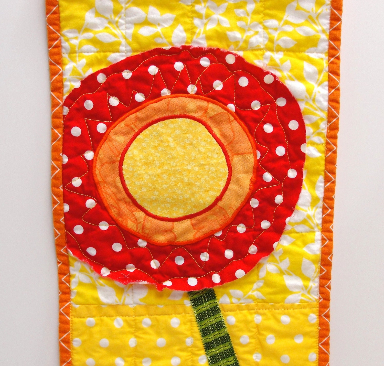 poppy wall quilt- single stem bright red, orange, and yellow on yellow and white background