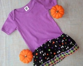 Last one size 12-18 months organic purple onezee with skirt for Halloween. Eyeballs with dots and plaid bottom ruffle.