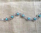 Vintage Sarah Coventry Round Turquoise Colored Cabochon Stone Filigree Silver Bangle Bracelet with Box Clasp