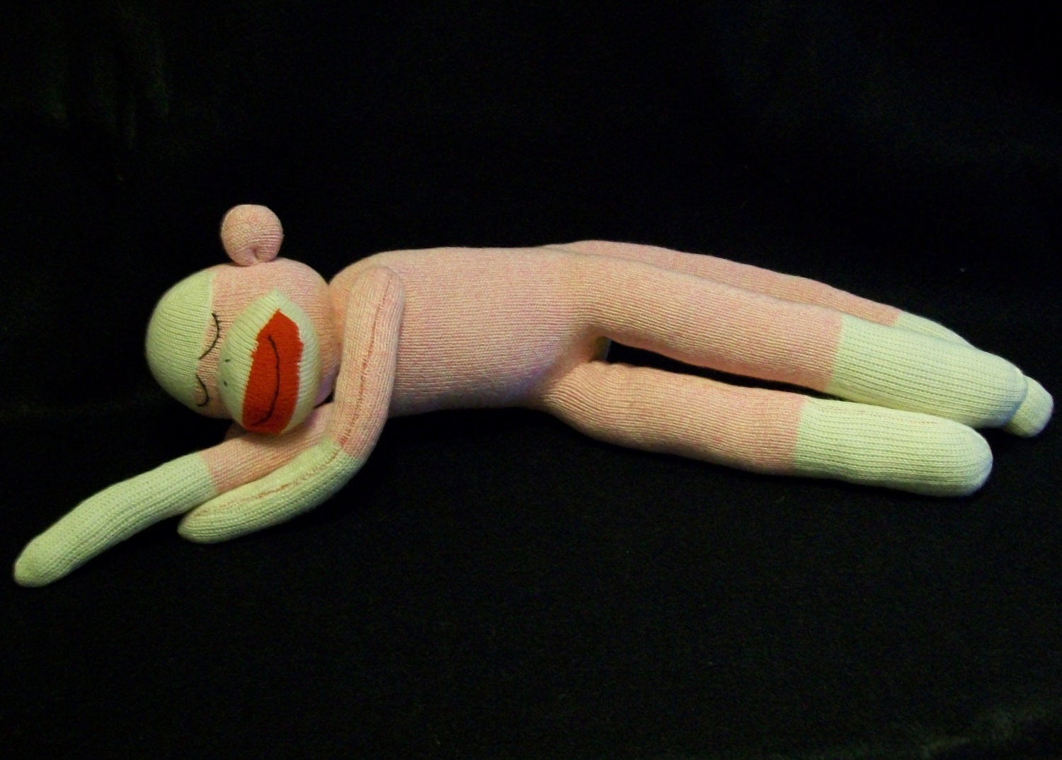 Pink classic red-heel sock Monkey sleeping