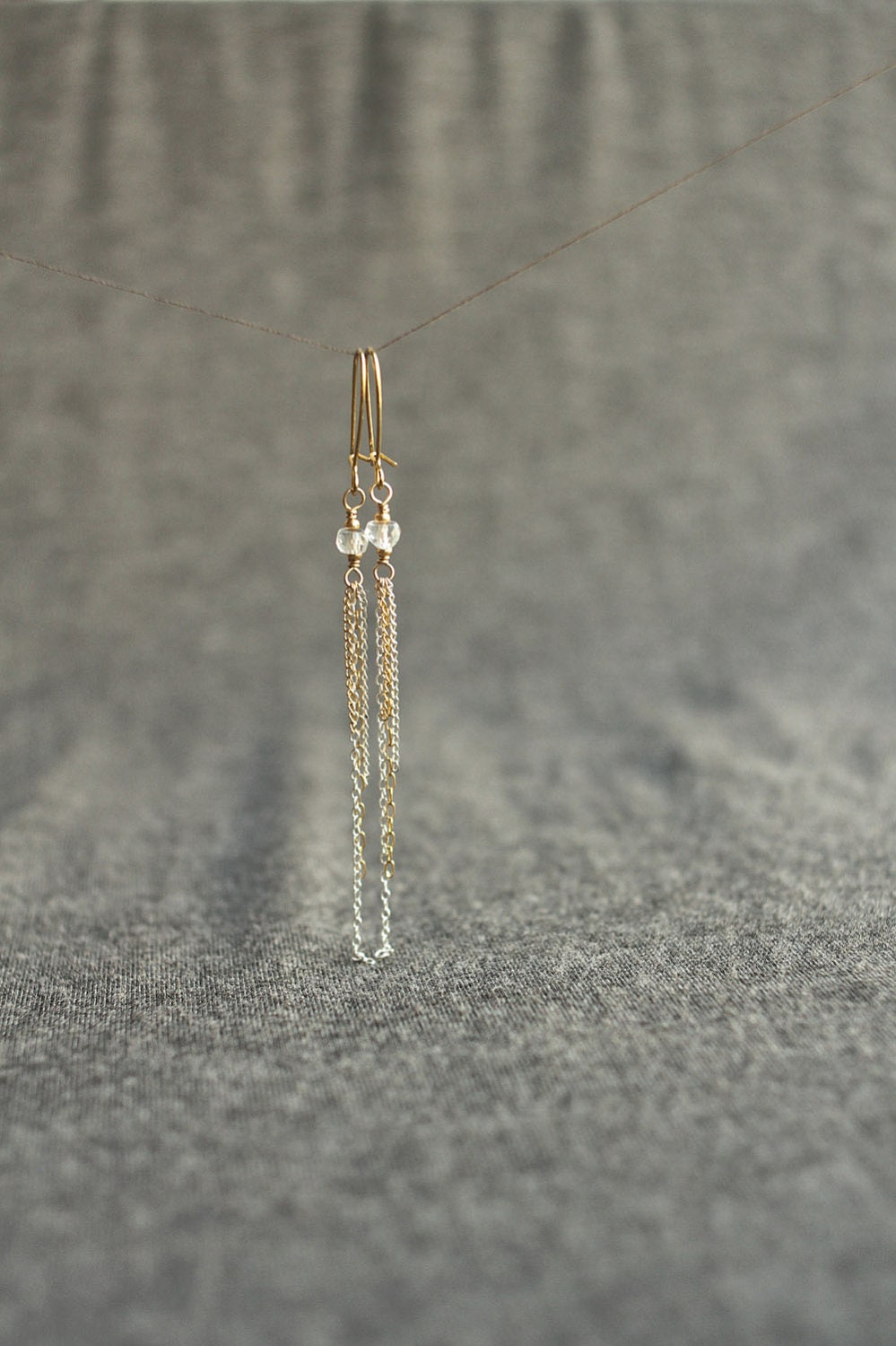 mixed metal tassel earrings with white topaz . leonid