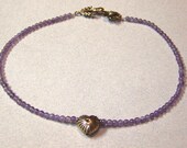 Amethyst beads with Brass Argyle Heart and Antiqued Brass Flower Closure