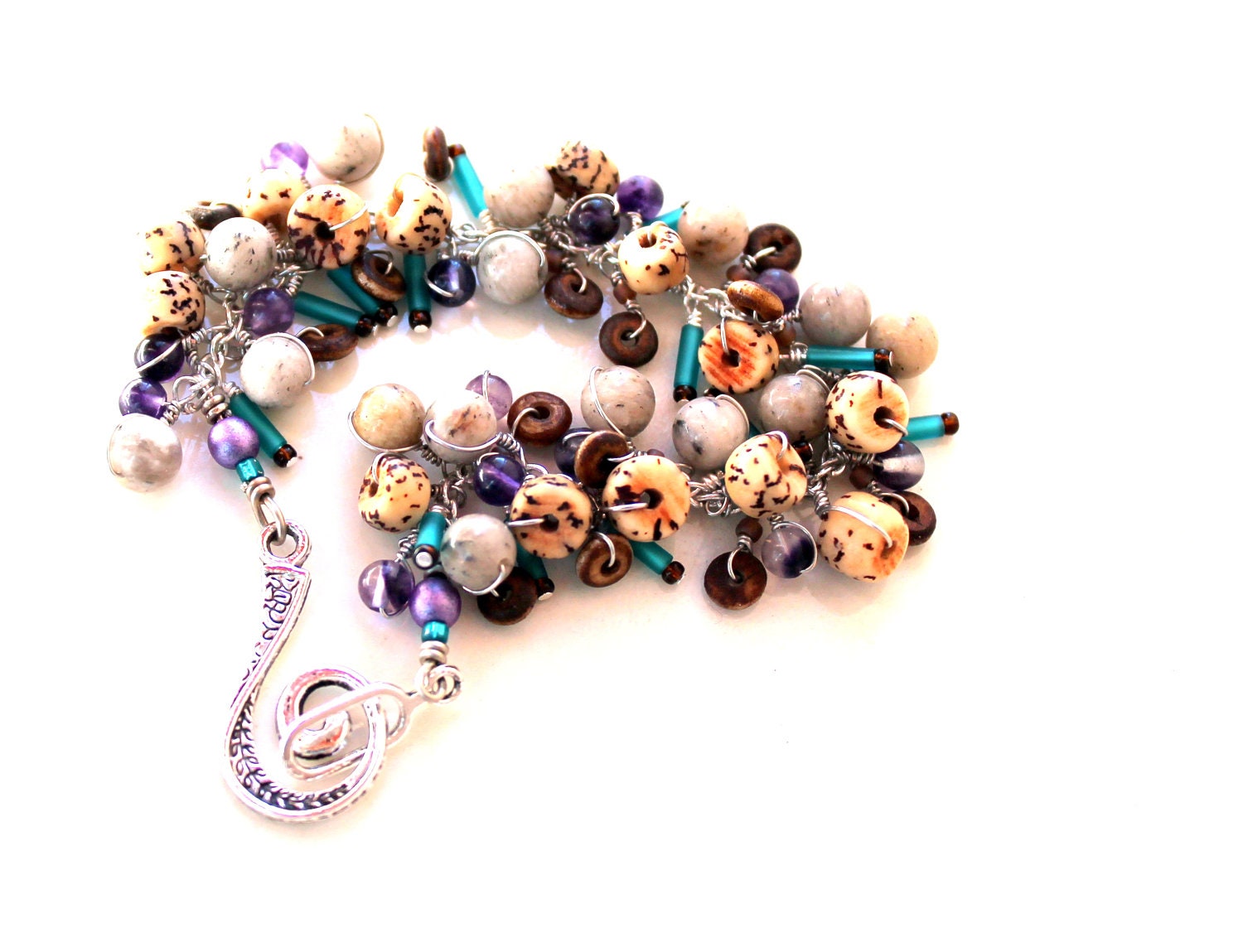 beadwork bracelet. artist exposed / buri nut spirals. feldspar bracelet. wire wrapped gemstones, purple teal sticks brown bracelet