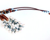 pearl wrapped necklace. juxtaposition. white pearls meets earthy. wood goldstone beads