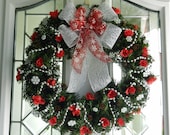 Christmas Wreath with snowflakes, red roses, silver bead garland, pine cones and bow .