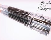 Bullet pen with black and silver braid. Bolt action ink advance. Very cool.