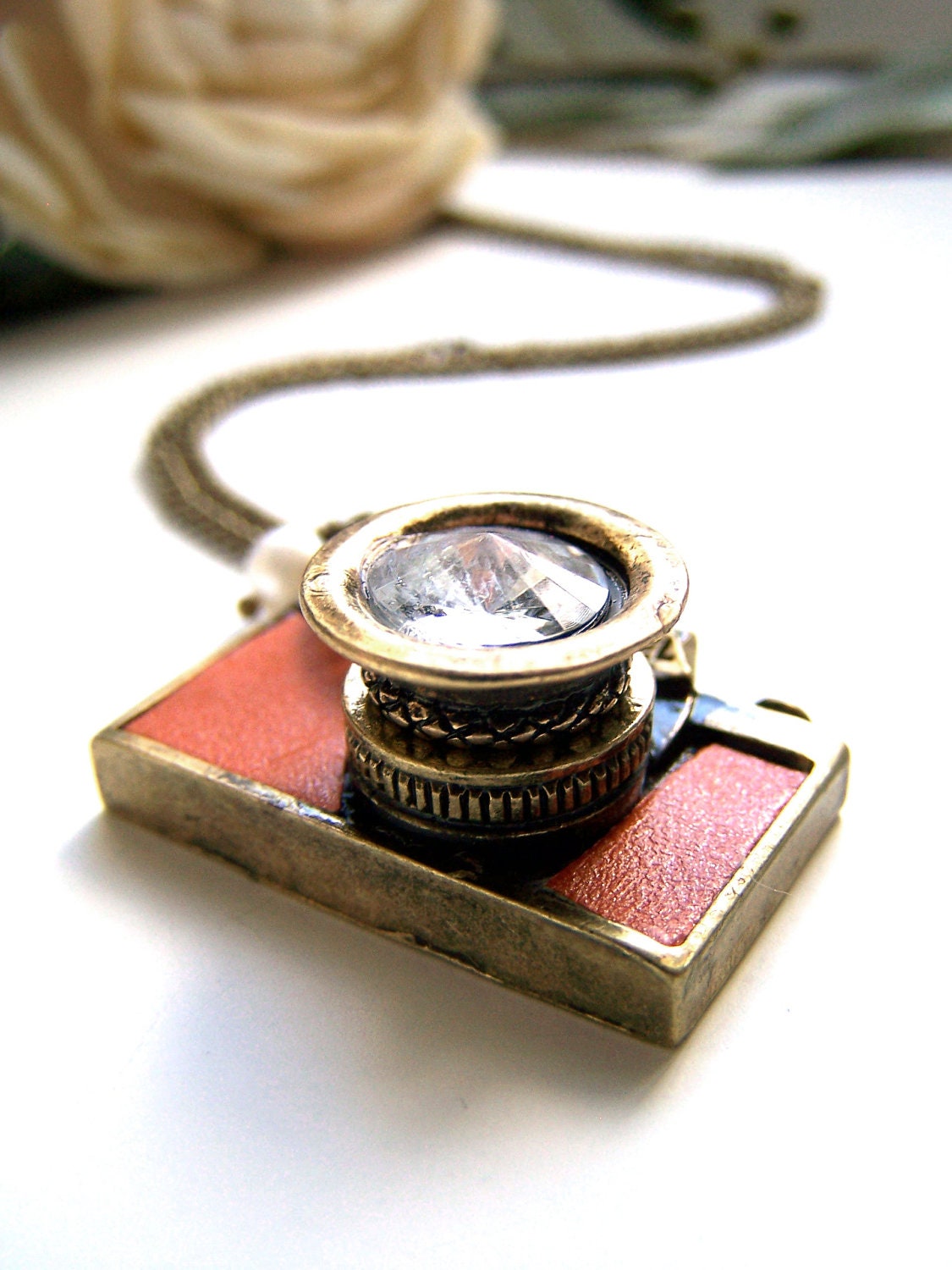 the tan leather camera necklace.