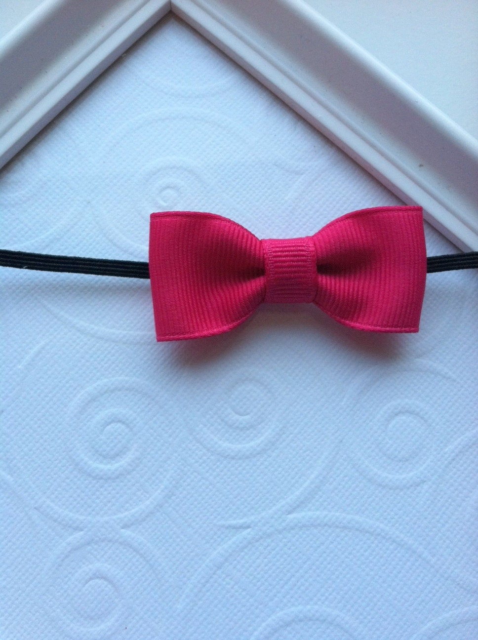 Shocking Pink Mini Tuxedo Bow attached to a Black Skinny Elastic Headband