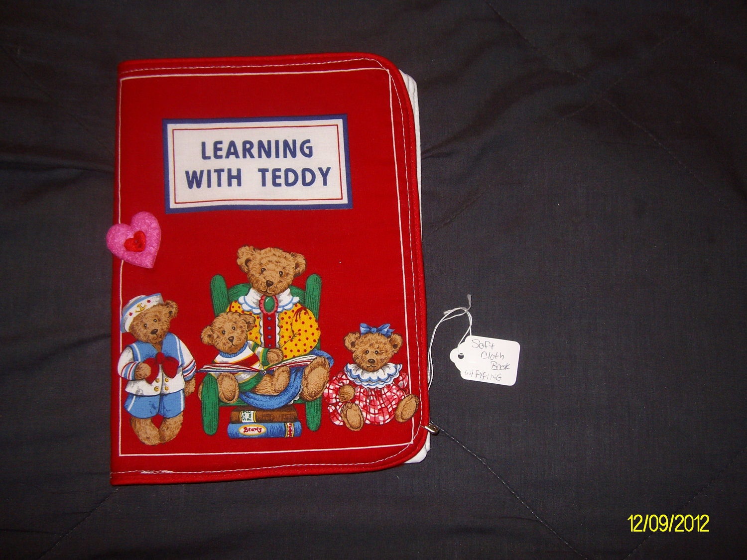 Learning with Teddy - a Soft Cloth  Book                  in bright bold colors and piping around the edges