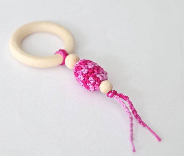 One simple teething toy with crochet wooden oliven bead. Pink teething rings toy.