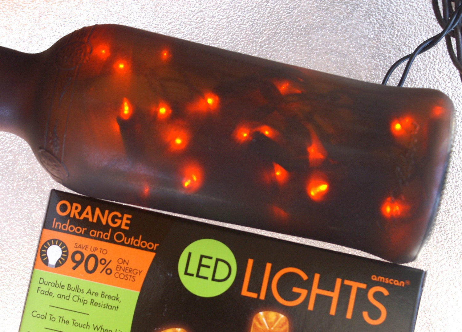 Orange Lights in Brown Frosted Glass Bottle