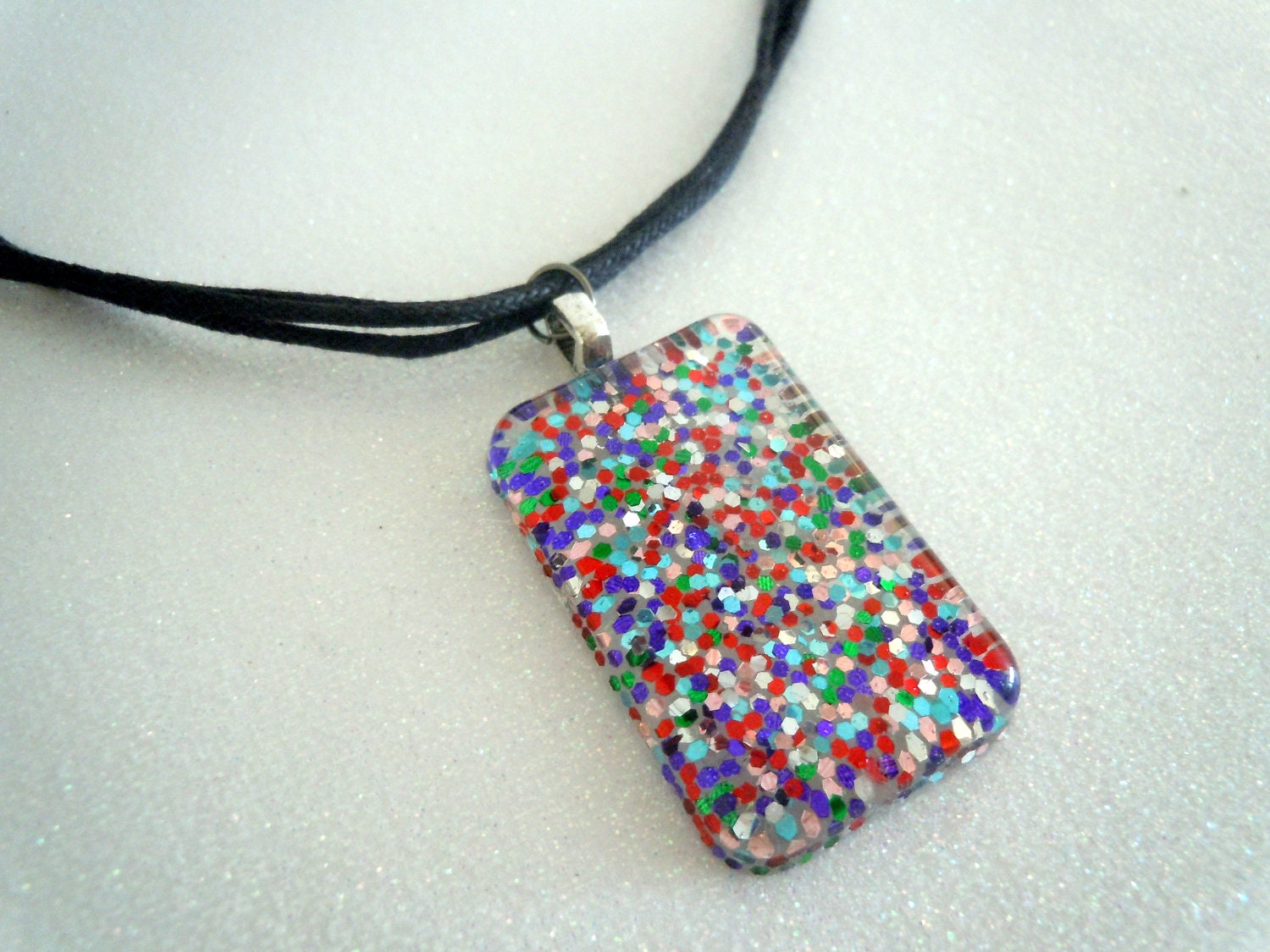Multi-color glitter charm -- black cord necklace