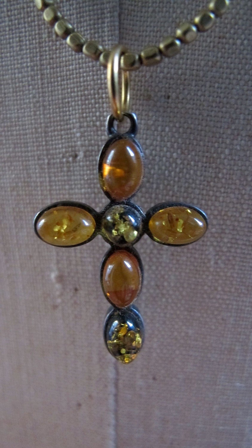 Necklace with Vintage Amber Cross Strung on Antique Indian Brass Beads