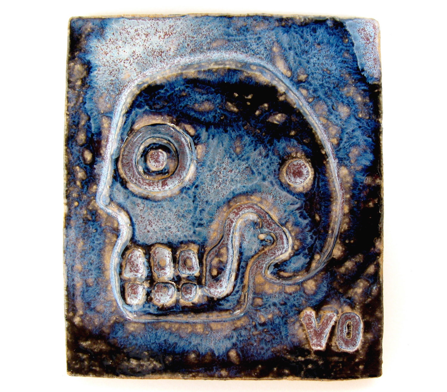 Skull Tile, handmade ceramic pottery art in indigo and black
