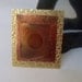 Copper brooch made from copper and brass sheet metal that was heat treated.