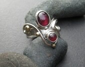 Garnet ring, flowing handmade sterling silver setting with two purplish red almandine garnet gemstones, size 7 and 1/2