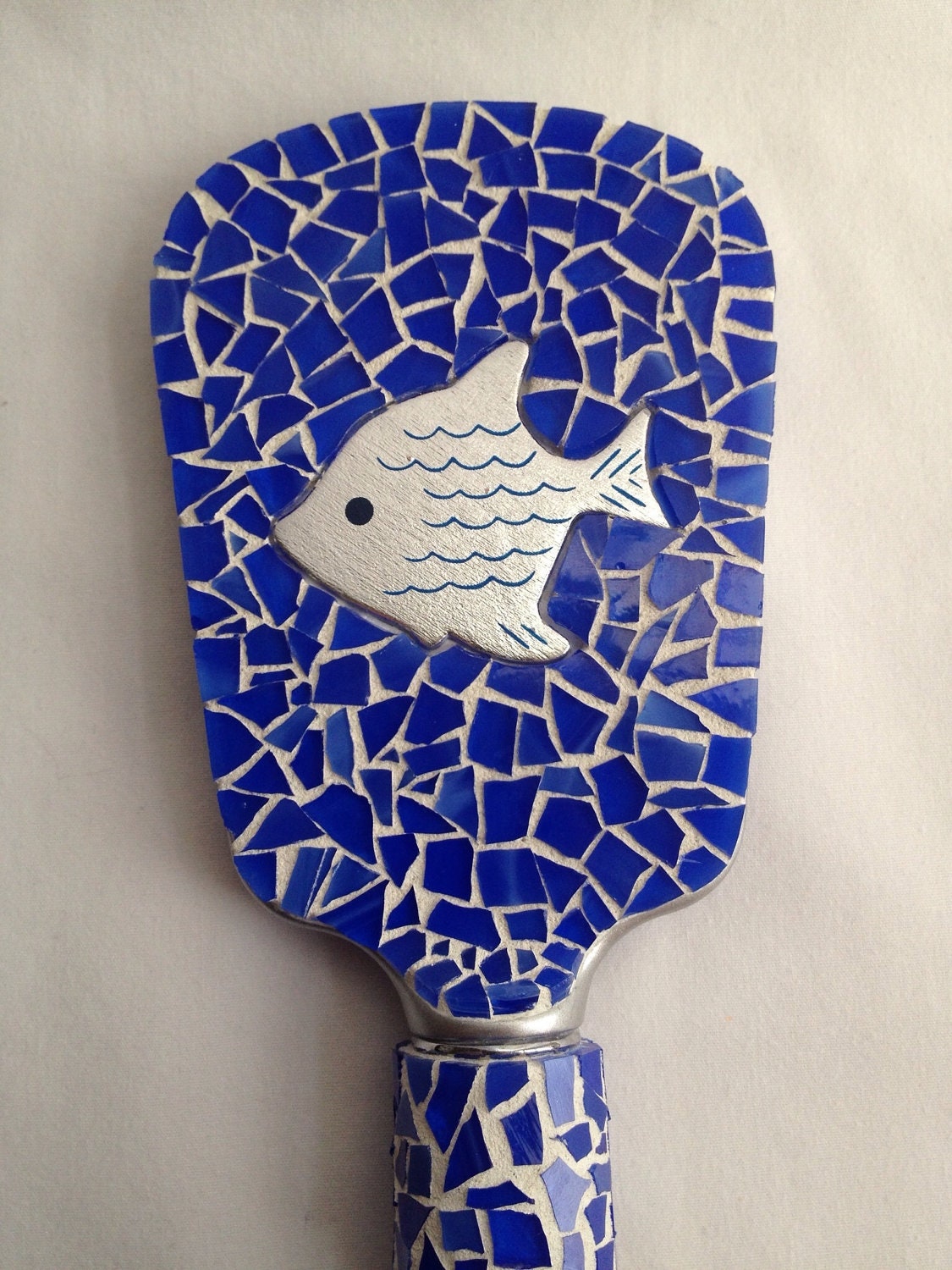 Now You Sea Me// Mixed media mosaic hand mirror with blue stained glass and silver fish bauble