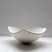 Stoneware fine bone china bowl with 10% real gold resembles a small boat.
