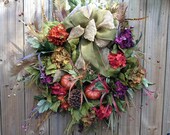 Fall wreath with sage green burlap bow, pumpkins and hydrangeas.