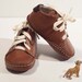 Baby shoes in toffee brown colour, 100% leather inside and outside. Beige or yellow cotton laces