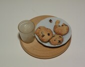 Dollhouse polymer clay miniature chocolate chip cookies and milk on a wood disk
