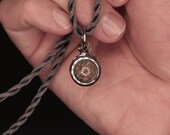 Miniature window terrarium window locket with green moss. Clear windows, silver frame. Super teeny globe