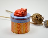 Round wooden trinket / treats box with a sleeping cat on top