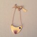 Gold triangle necklace with a tiny black Swarovski crystal, modern design, stylish and very unique.