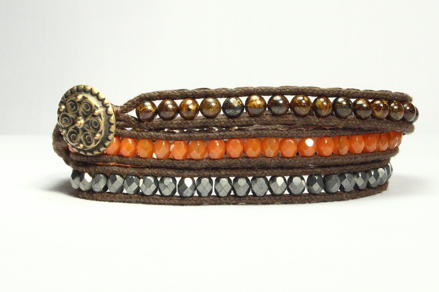Wrap bracelet.  Bronzite brown gemstones, pumpkin orange and graphite gray fire polish glass beads.  Antique gold button.  Fall colors.