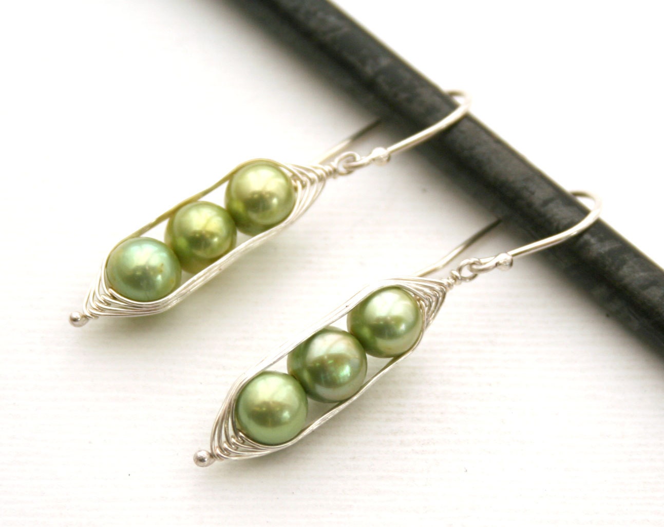 Peapod earrings. Three peas in a pod with green fresh water pearls.