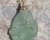 Beautiful, rare color, aqua marine seaglass pendant handwrapped in sterling silver wire.
