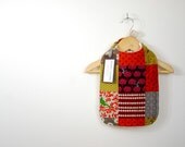 baby bib, heavy natural cotton, earthy autumnal quilted look, birds and branches, baby and parent friendly.