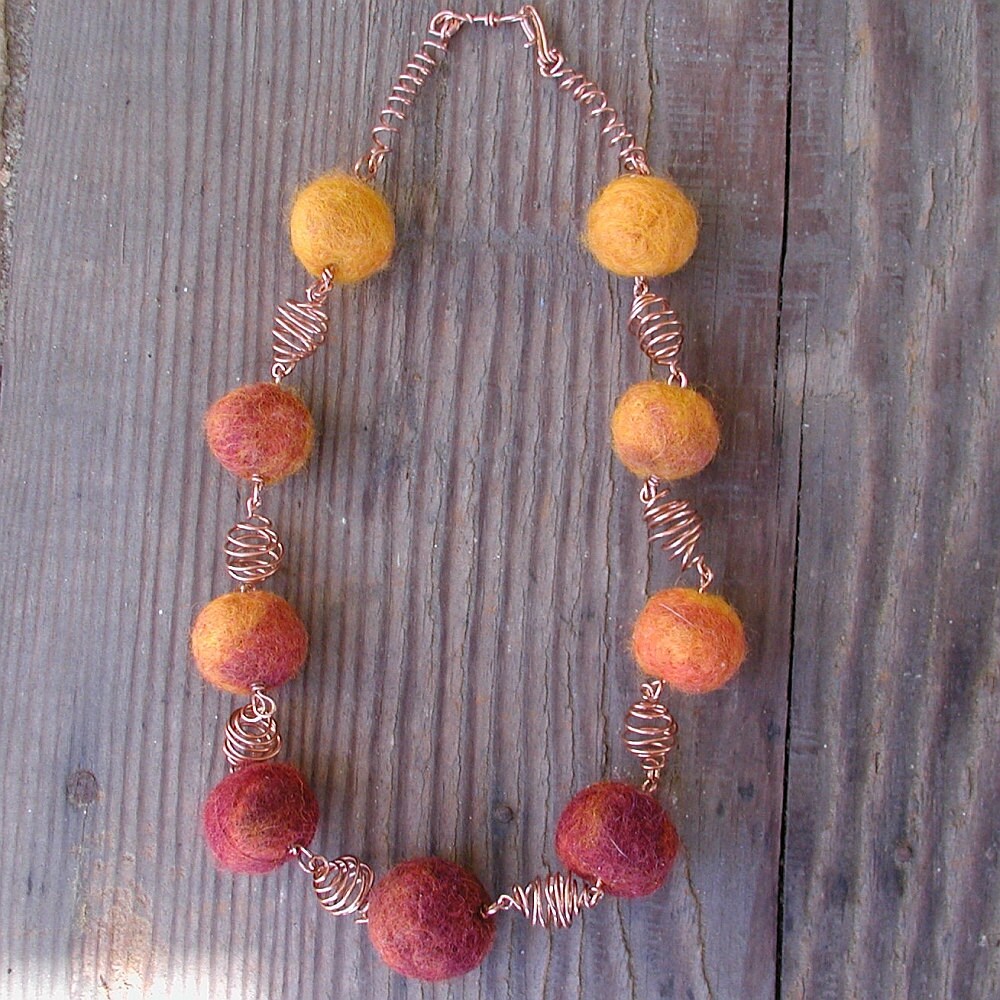  I'm now making these beautiful little felted wool beads in all kinds of colors! This one is a wonderful orange-gold combination which is perfect with the copper wire beads which I've formed. Also available in yellow/green and royal blue. The necklace is 18" long and has a hook and eye closure. Nine beads.I can change the length if you will let me know what you prefer. 