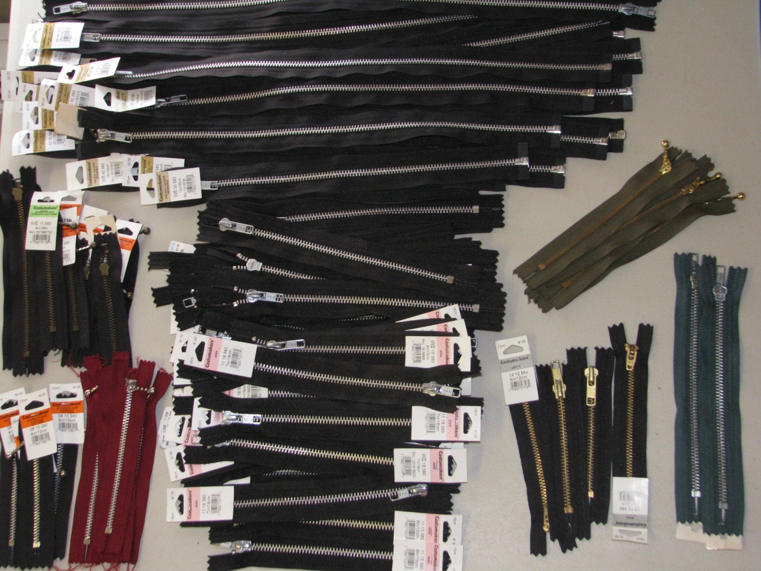 Over 100 Zippers Most of them are YKK Zippers Black and Silver Metal