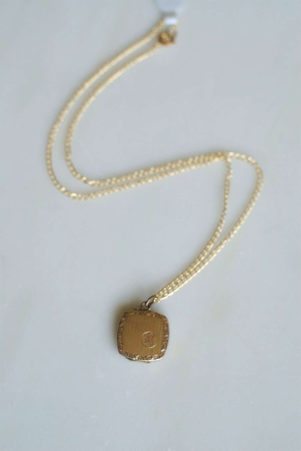 vintage gold locket engraved with the letter "R"