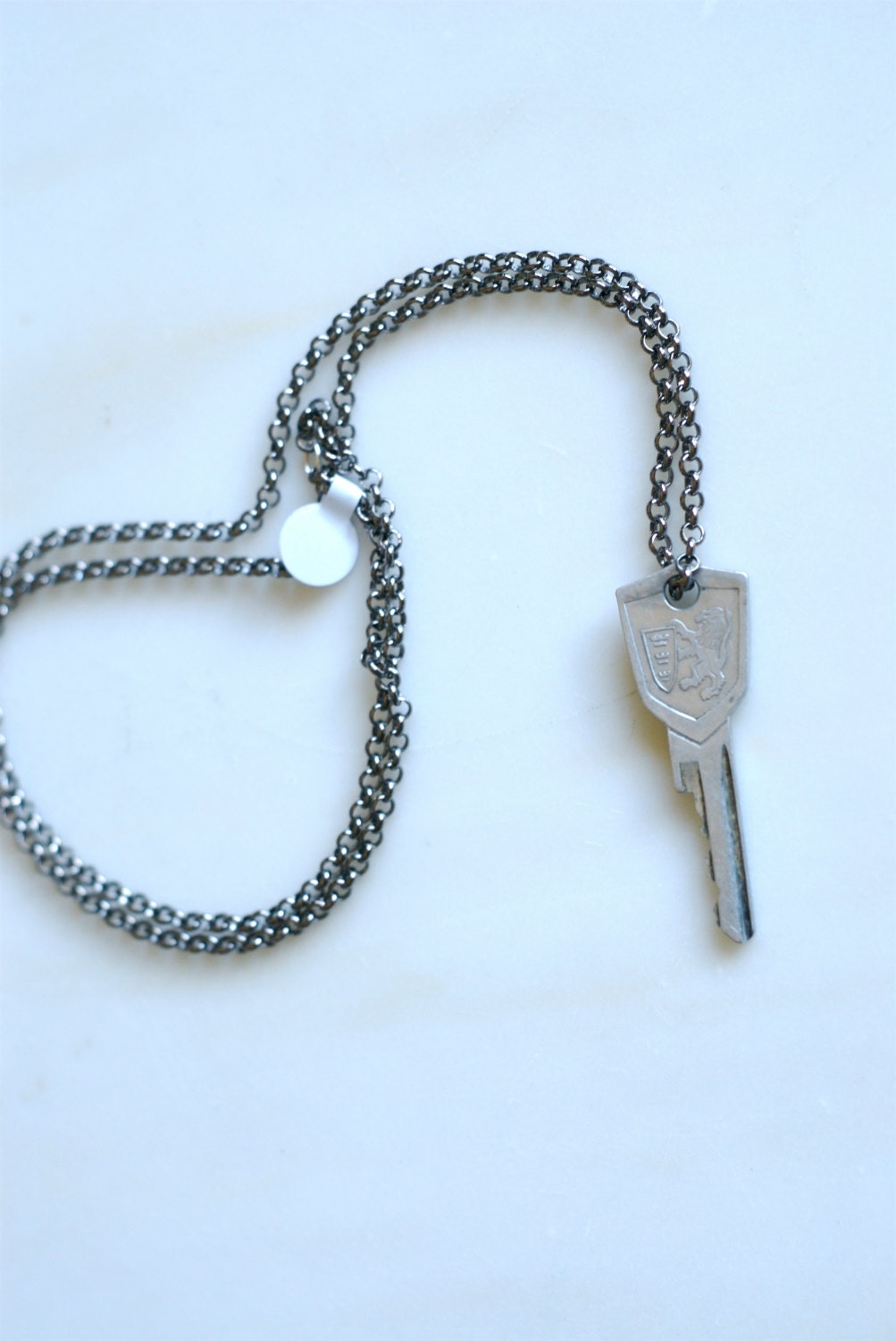 vintage lion crest key on a 15 inch gun smoke silver chain