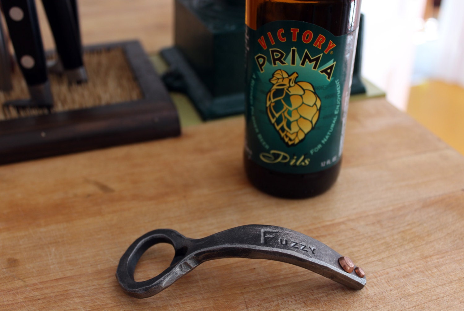 A Fuzzy Forged Steel Bottle Opener with a Couple Copper Rivets