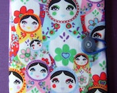 Russian doll passport cover made with a rare fabric with a button elastic loop closure