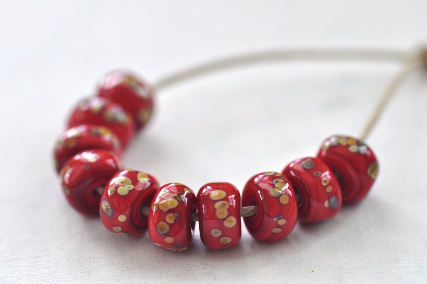 p i n o c e a n lampwork beads set ( 10 ) - pebbles / red and reku frit  -
