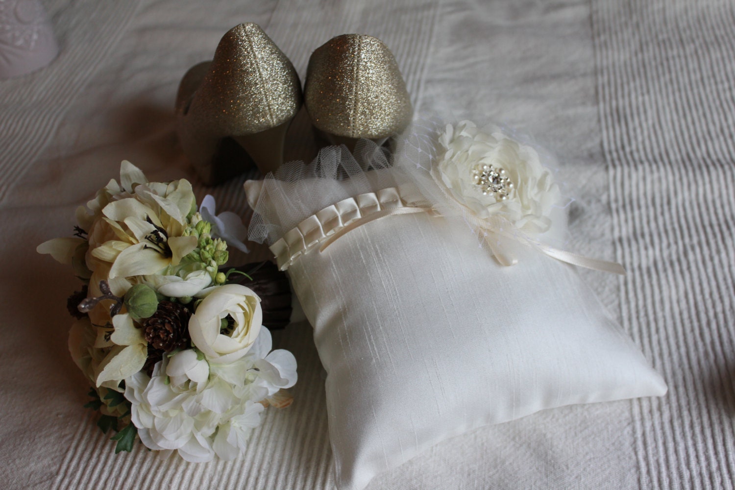 Isabella, a beautiful ivory chiffon camellia flower with a rhinestone and pearl center stand out on this pillow