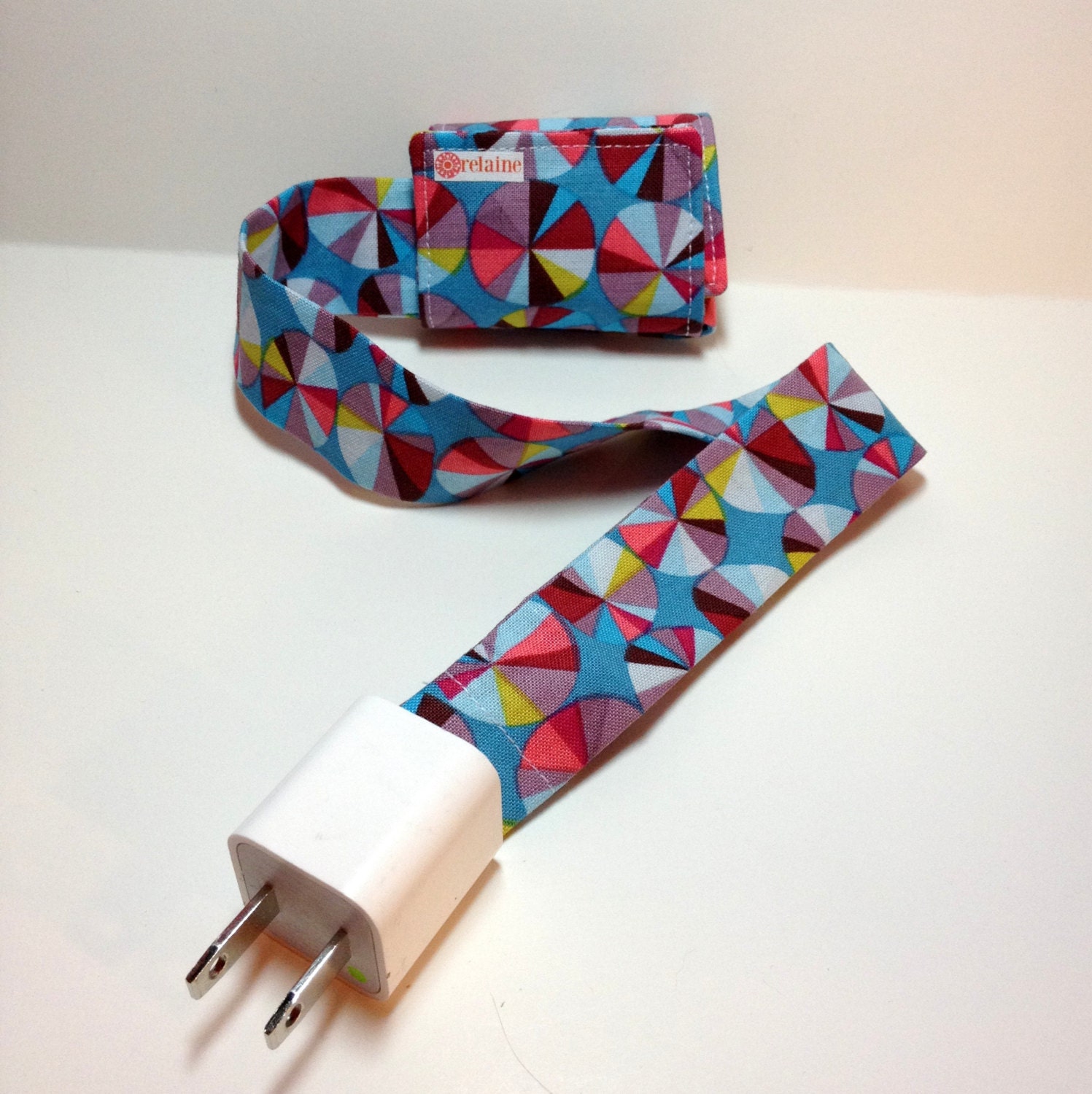PowerTube.  Charging cord organizer for iPhone or iPod.  Cord keeper.  Cord organizer.  Power cord case.