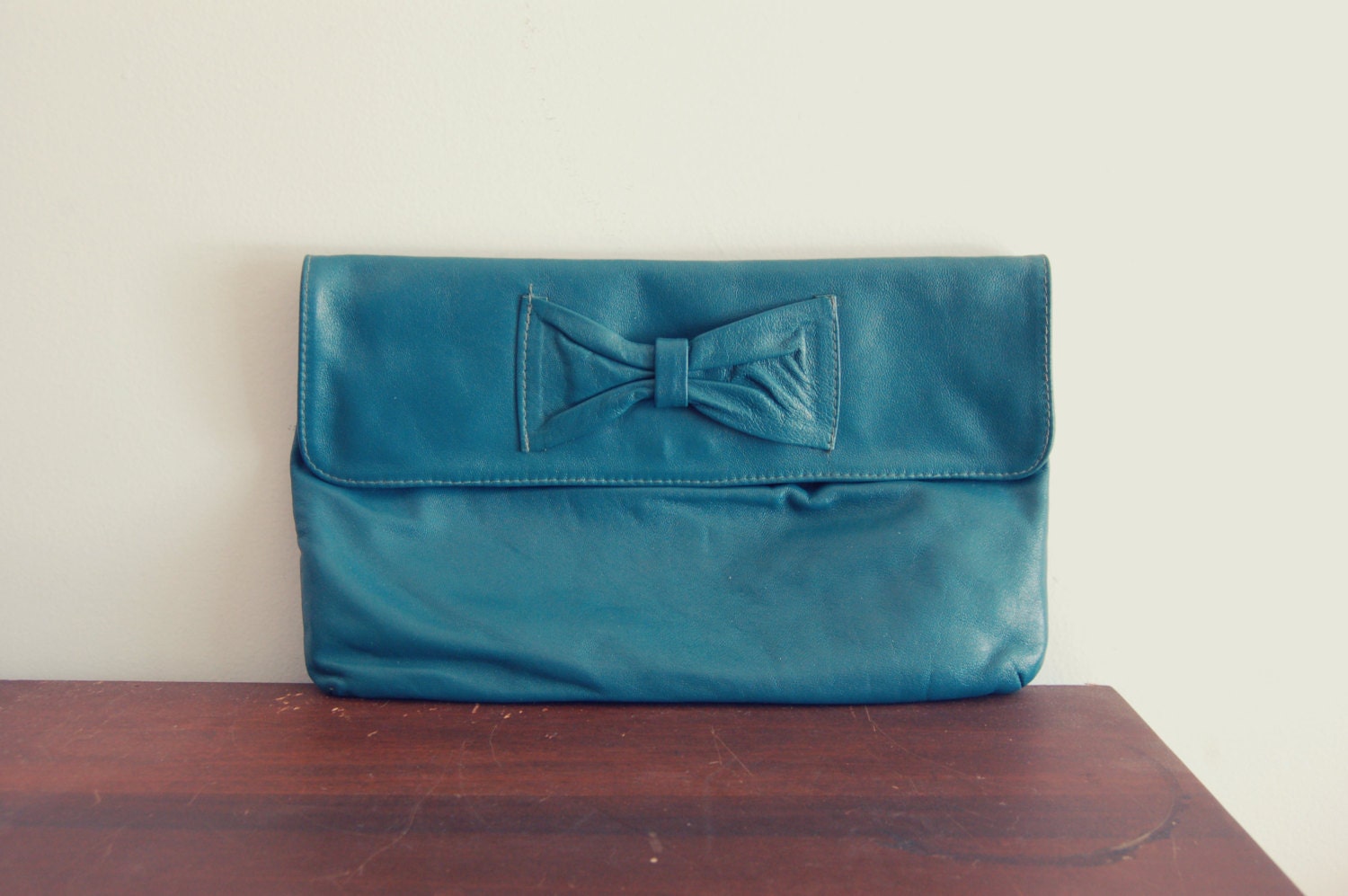 leather bow clutch in emerald green