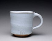 handmade pottery mug, ceramic cup, teacup with a shiny white ash glaze and orange shino