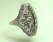 An 18k White Gold and Diamond Filigree and Flowers Motif Ring, Circa 1925.